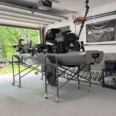 Garage with camping gear and equipment, including a bed frame and storage boxes.