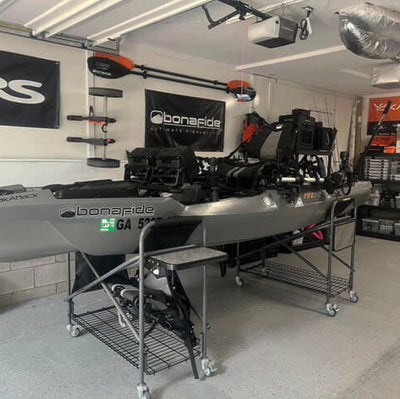 Paddleboard on a rack in a garage with NRS and Bonafide branding.