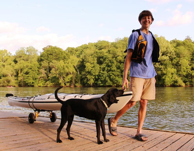 Man pulling a kayak on a SK Cart on a dock