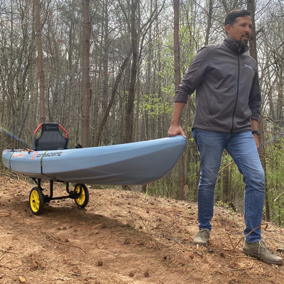 Man pulling a kayak on the catch-all cart