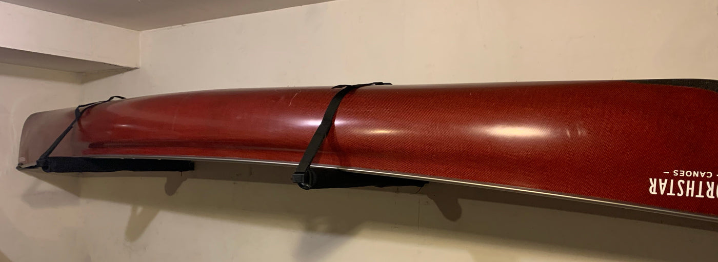 A canoe mounted upside down on a canoe rack.