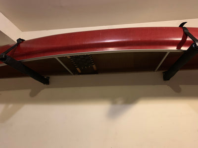 Bottom perspective of the canoe mounted upside down on a canoe rack.