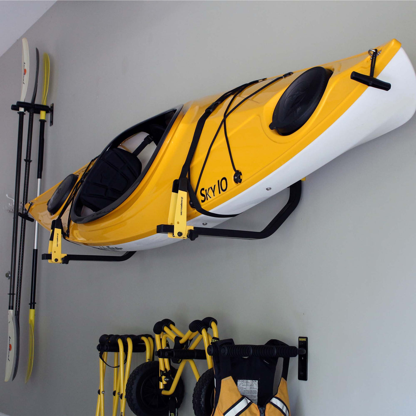 One Deluxe Rack with yellow kayak mounted to a garage wall.