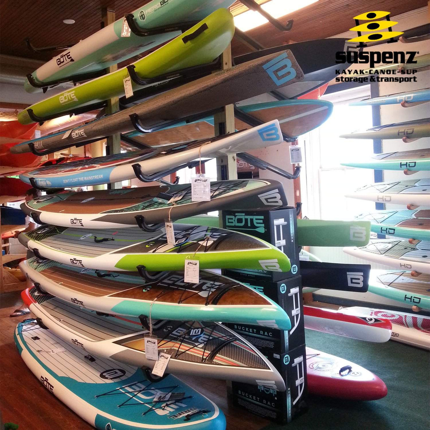 A store displaying their SUP boards on the display flat rack