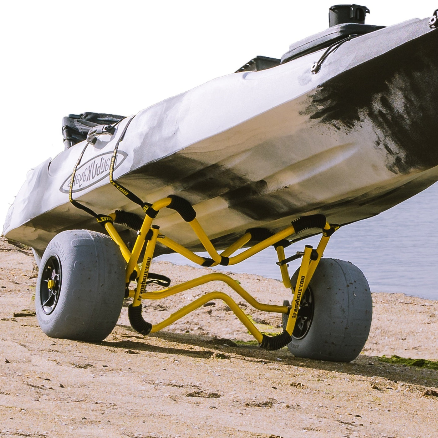 A boat resting on the heavy duty deep-v beach cart on the beach.