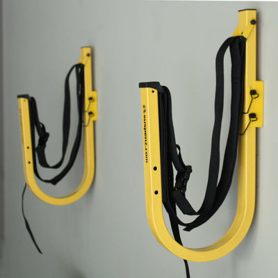 1 set of stand-up paddleboard wall storage mounted to a garage wall 
