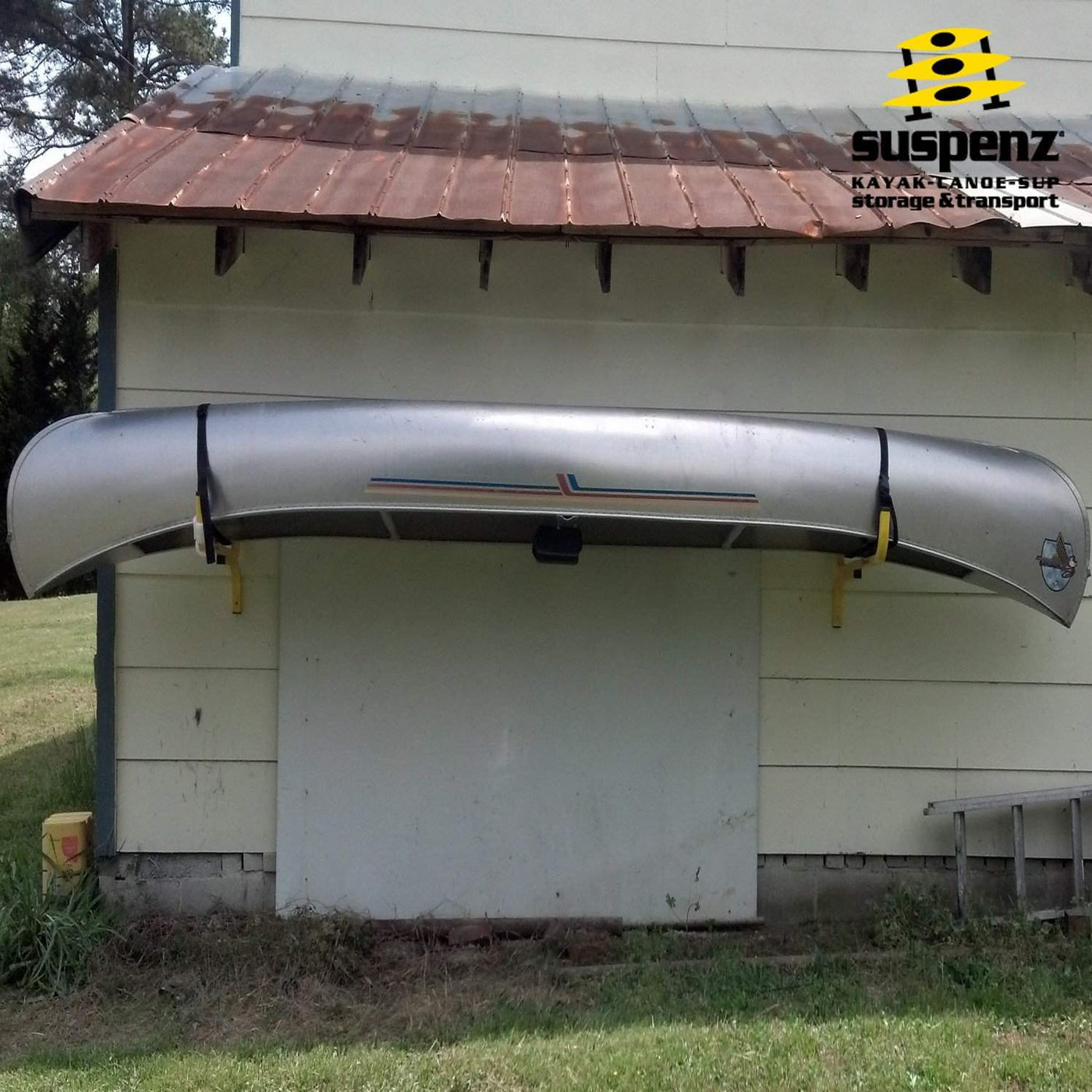 One FLAT Rack and one canoe (stored upside down) mounted to a shed.