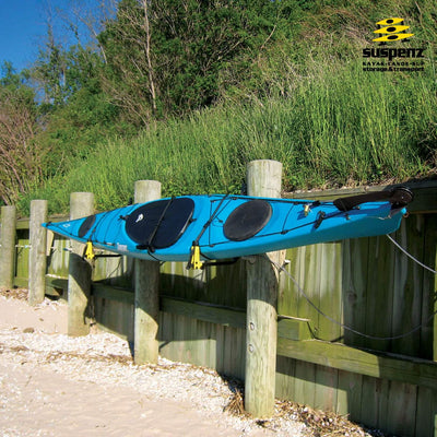 One Deluxe Rack and blue kayak mounted to wooden post on the beach.